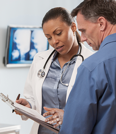 Doctor discusses with patient the options available from his medical insurance coverage