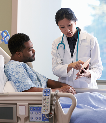 Man with stable but critical condition discussing health status with doctor